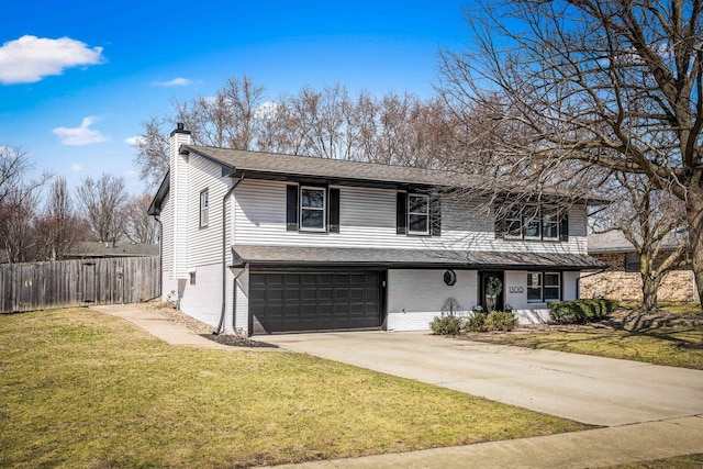 traditional-style home featuring fence, a front yard, a chimney, a garage, and driveway