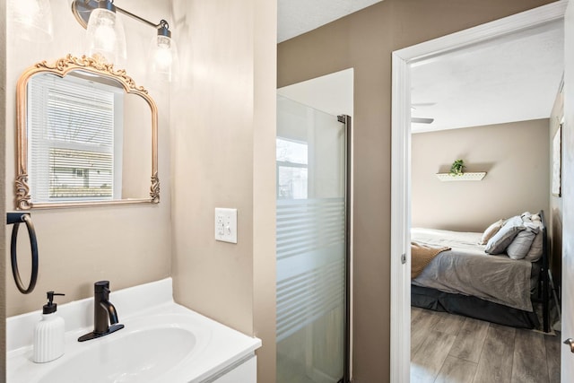 bathroom featuring a wealth of natural light, a shower stall, ensuite bath, and wood finished floors