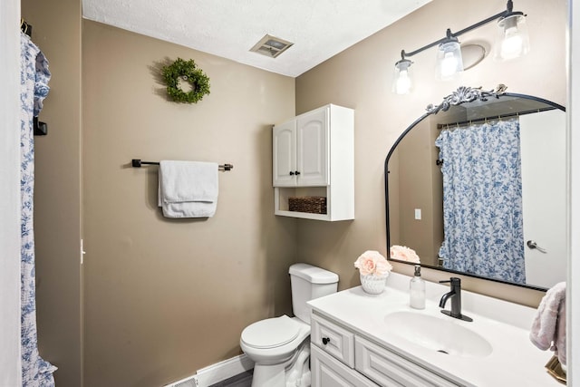 full bath with visible vents, toilet, a textured ceiling, baseboards, and vanity