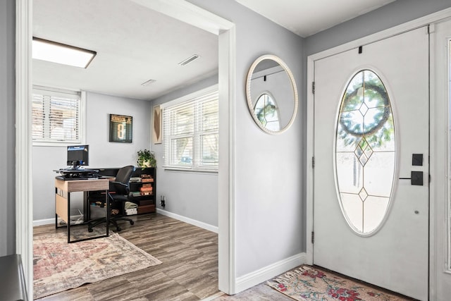 entryway featuring visible vents, wood finished floors, and baseboards