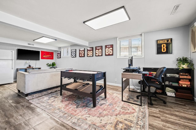 rec room with visible vents, baseboards, and wood finished floors