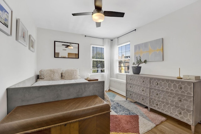 bedroom featuring wood finished floors and a ceiling fan