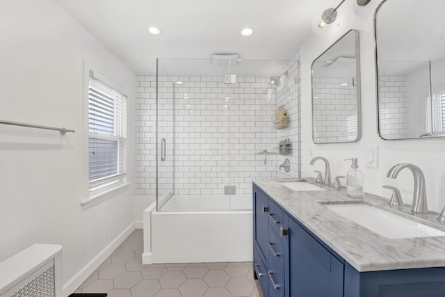 bathroom with a sink, baseboards, shower / bath combination with glass door, and tile patterned flooring