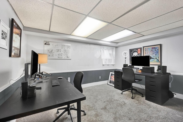 carpeted home office featuring a drop ceiling