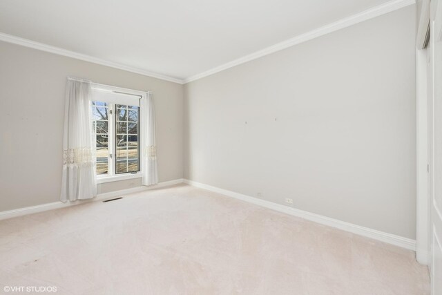 unfurnished room with visible vents, baseboards, light colored carpet, and ornamental molding