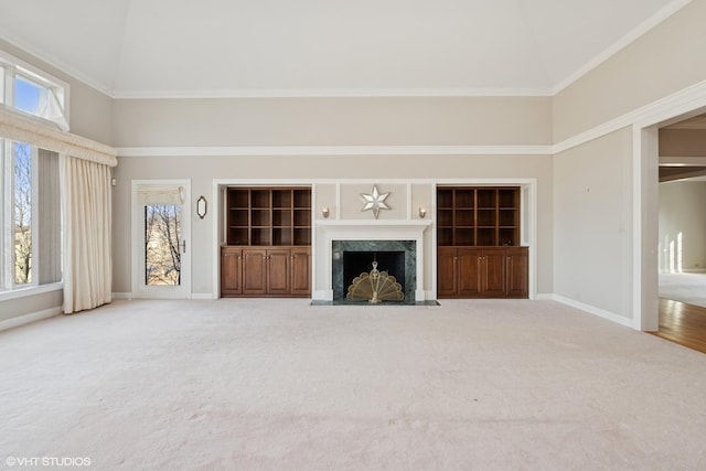 unfurnished living room with plenty of natural light, high vaulted ceiling, and a fireplace