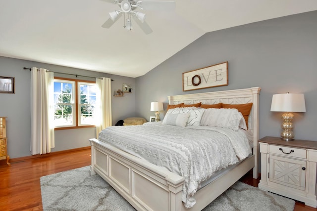 bedroom featuring a ceiling fan, vaulted ceiling, light wood-style floors, and baseboards