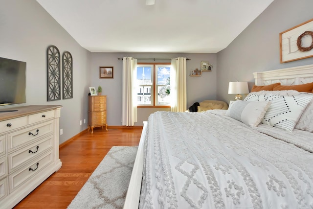 bedroom with light wood-type flooring and baseboards