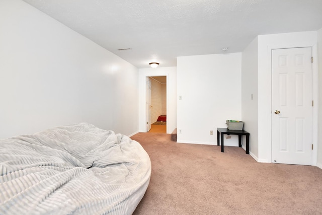 bedroom featuring light colored carpet and baseboards