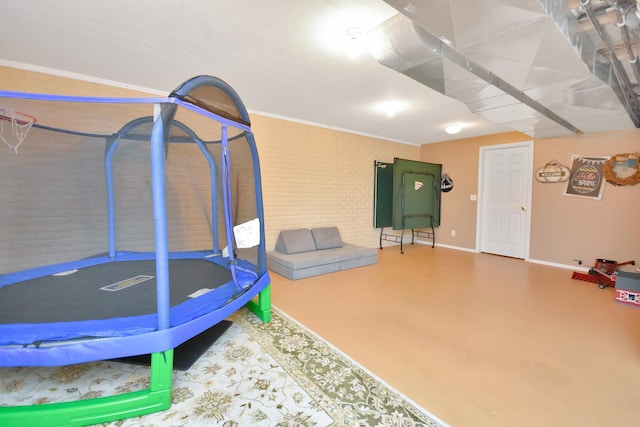 workout room with baseboards and crown molding