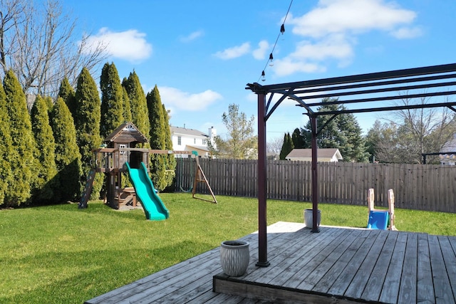 view of jungle gym with a lawn, a fenced backyard, and a wooden deck