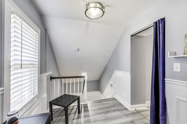 interior space featuring wood finished floors and vaulted ceiling