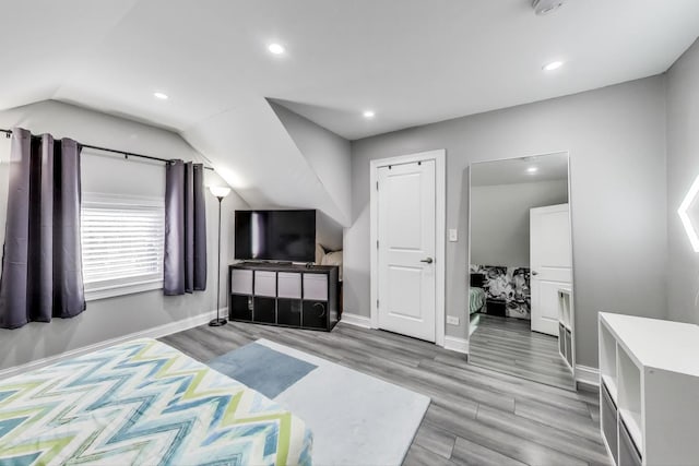 bedroom with vaulted ceiling, recessed lighting, baseboards, and light wood-type flooring