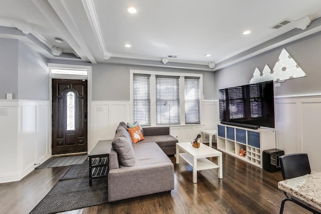 living area with a wainscoted wall, recessed lighting, wood finished floors, and visible vents