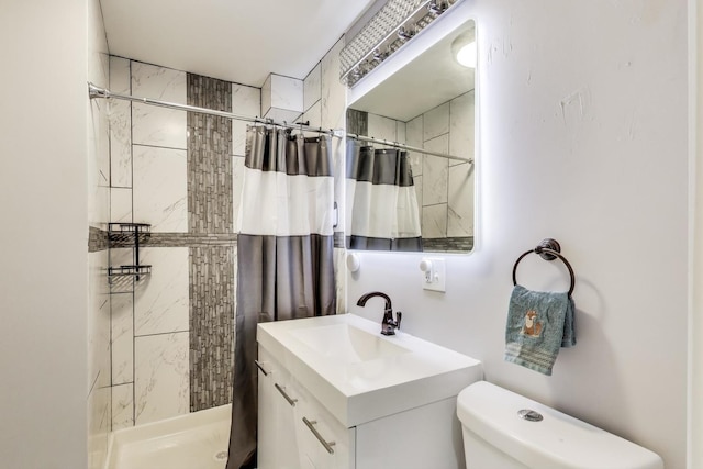 bathroom with vanity, toilet, and a stall shower