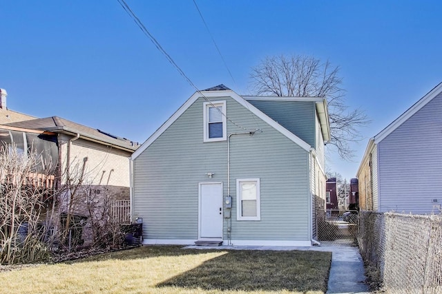 back of property featuring a yard, cooling unit, and fence