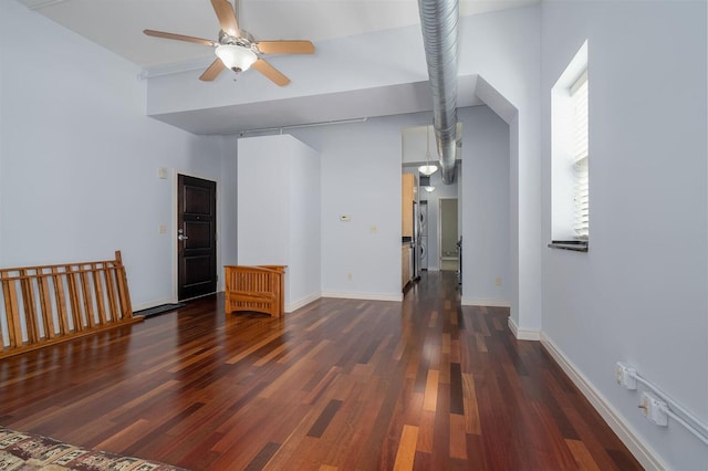 interior space featuring dark wood-style floors, baseboards, and ceiling fan