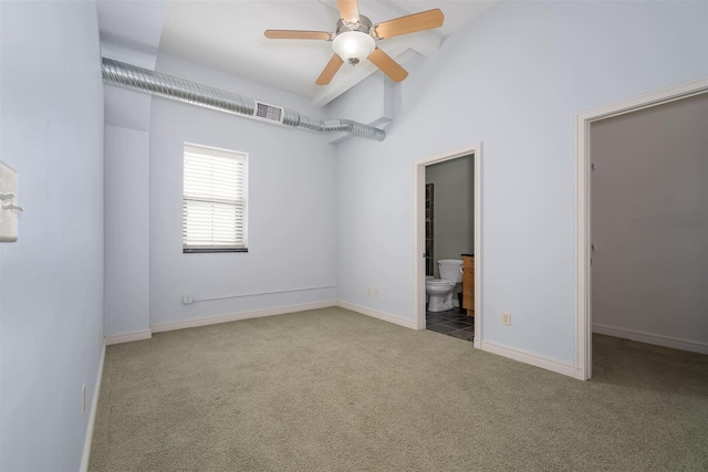 carpeted empty room with visible vents, baseboards, lofted ceiling, and a ceiling fan