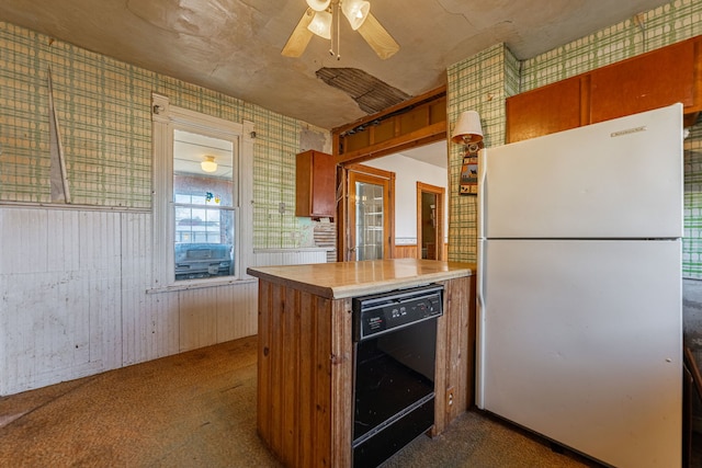 kitchen with wallpapered walls, ceiling fan, dishwasher, carpet flooring, and freestanding refrigerator