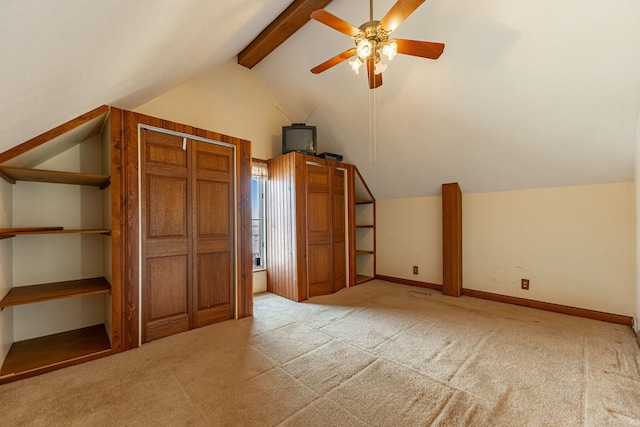 additional living space with ceiling fan, vaulted ceiling with beams, baseboards, and carpet floors