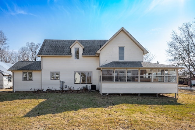 rear view of house featuring cooling unit, a shingled roof, a yard, and a sunroom