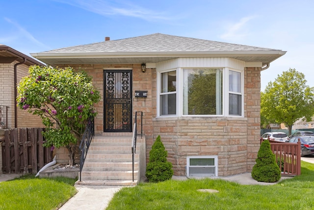 4556 N Newcastle Ave, Harwood Heights, IL 60706 - bungalow featuring stone siding, fence, and roof with shingles