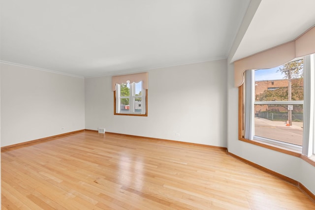 4556 N Newcastle Ave, Harwood Heights, IL 60706 - spare room featuring healthy amount of natural light, light wood-style floors, ornamental molding, and baseboards