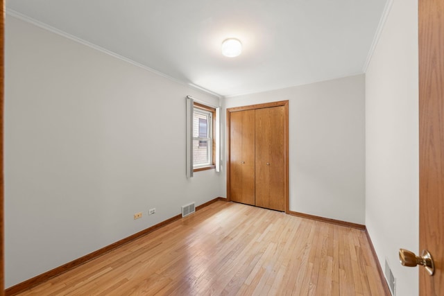 4556 N Newcastle Ave, Harwood Heights, IL 60706 - unfurnished bedroom featuring light wood finished floors, baseboards, a closet, and ornamental molding