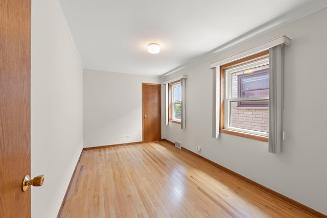 4556 N Newcastle Ave, Harwood Heights, IL 60706 - unfurnished room with light wood-style floors, baseboards, and crown molding