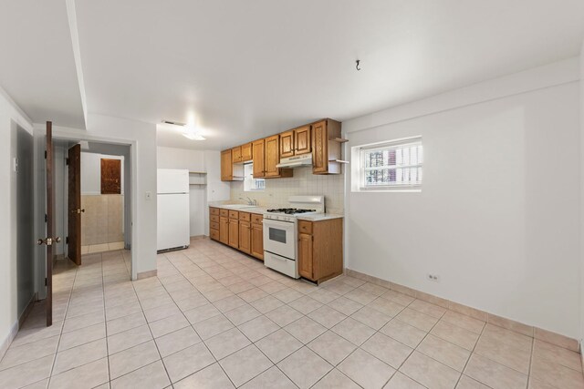4556 N Newcastle Ave, Harwood Heights, IL 60706 - kitchen featuring white appliances, a sink, under cabinet range hood, light countertops, and light tile patterned floors