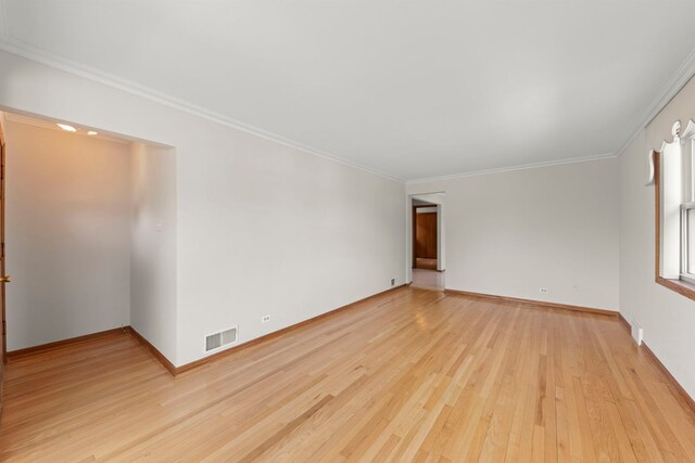 4556 N Newcastle Ave, Harwood Heights, IL 60706 - empty room featuring light wood-style floors, crown molding, and baseboards
