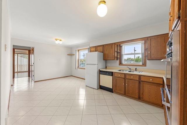 4556 N Newcastle Ave, Harwood Heights, IL 60706 - kitchen featuring white appliances, a sink, brown cabinetry, and light countertops