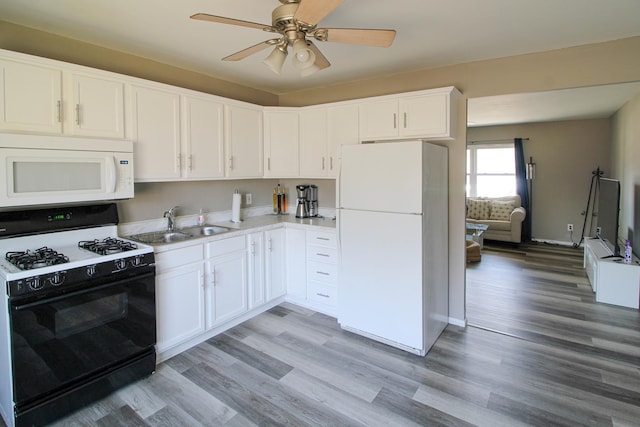 kitchen featuring a sink, white appliances, a ceiling fan, and light wood finished floors