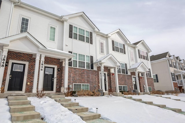 townhome / multi-family property featuring brick siding and a residential view