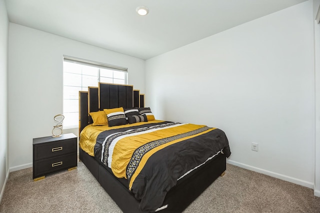 bedroom featuring light carpet and baseboards