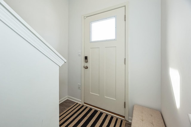 foyer entrance featuring wood finished floors and baseboards