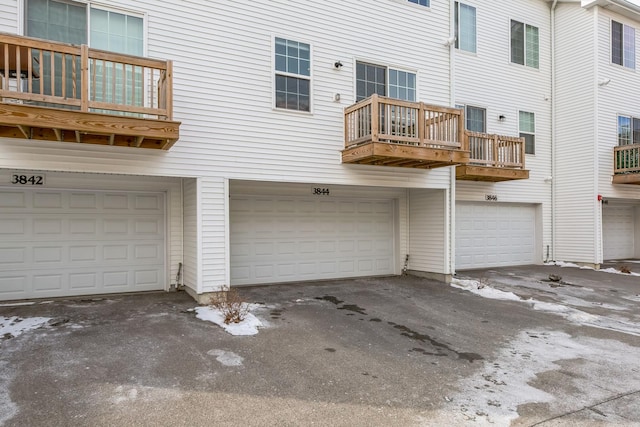 rear view of property with an attached garage