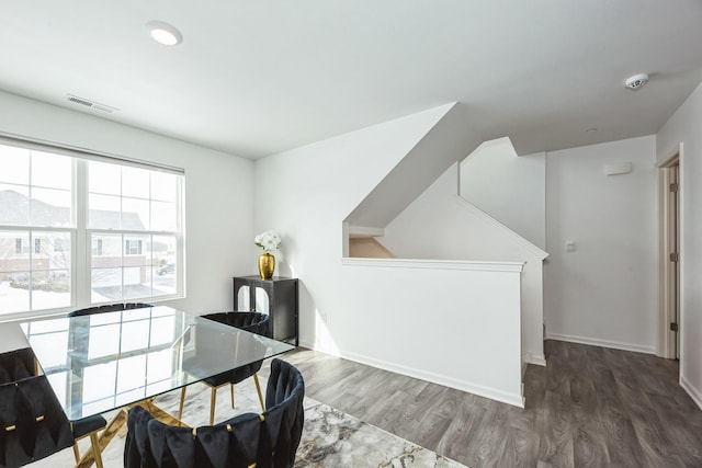 home office with wood finished floors, visible vents, and baseboards