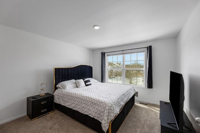 bedroom with visible vents, carpet floors, and baseboards