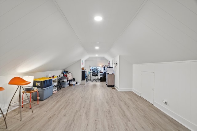 additional living space featuring baseboards, lofted ceiling, and wood finished floors