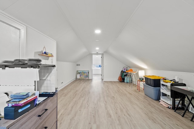 interior space featuring lofted ceiling, wood finished floors, and baseboards