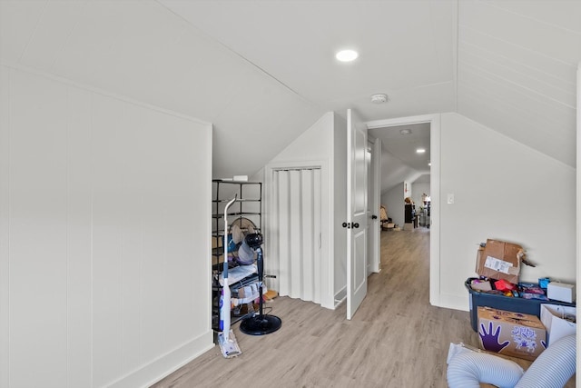 bonus room featuring light wood-type flooring and lofted ceiling