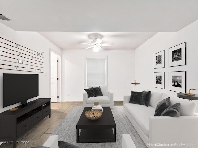 living area with visible vents, baseboards, and ceiling fan