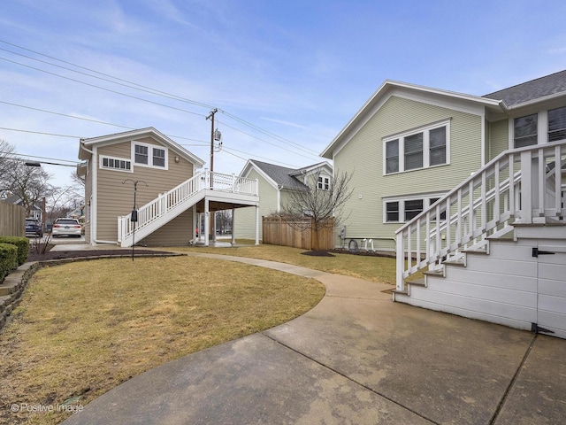 view of home's exterior with a yard and stairs