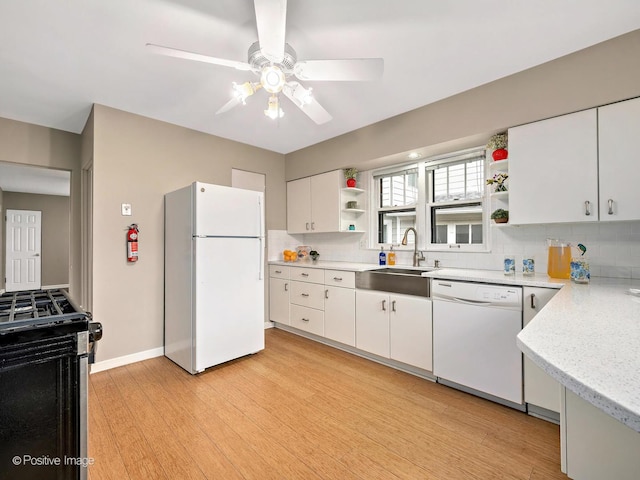 kitchen featuring backsplash, white appliances, open shelves, and a sink