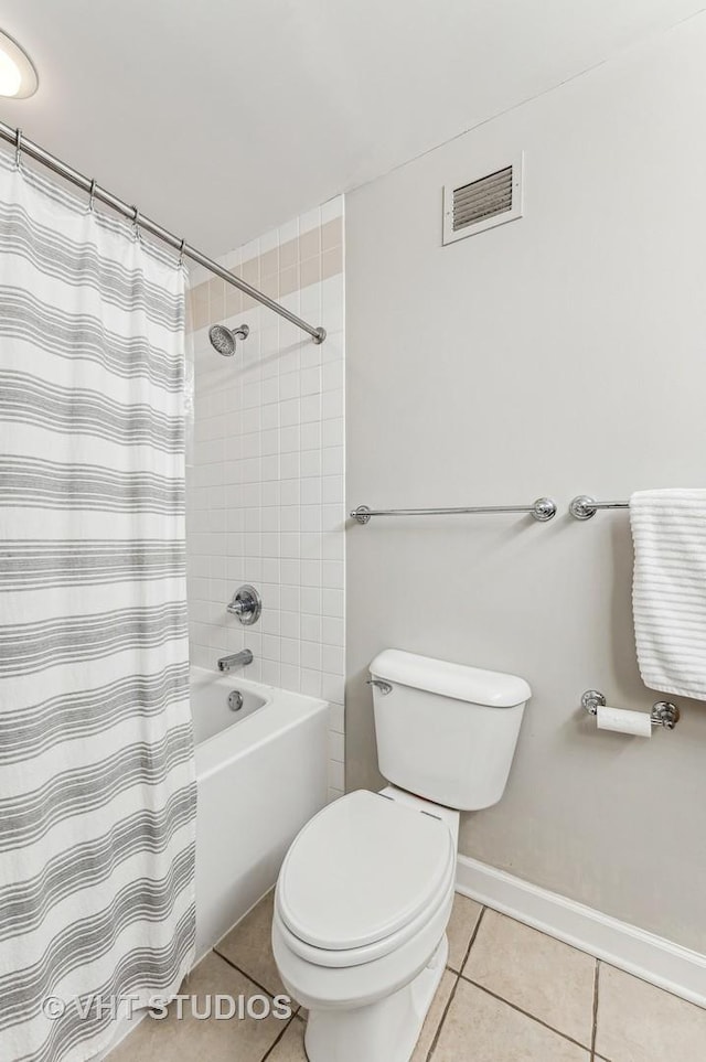 full bathroom with tile patterned flooring, visible vents, baseboards, toilet, and shower / bathtub combination with curtain