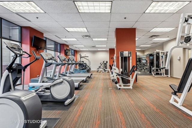 gym featuring visible vents and a paneled ceiling