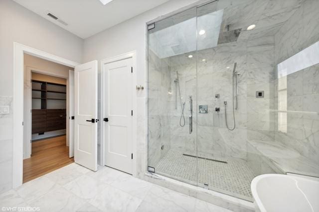 full bath featuring a marble finish shower, visible vents, a freestanding bath, recessed lighting, and marble finish floor