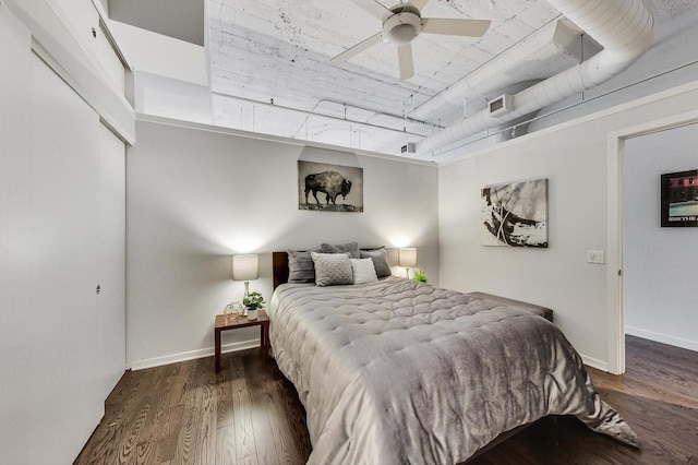bedroom featuring visible vents, baseboards, and wood finished floors