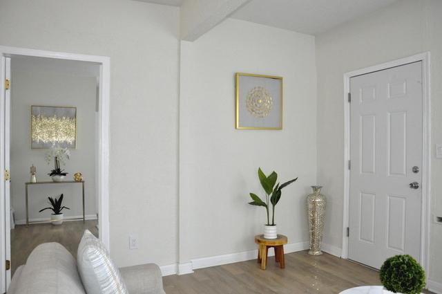 entrance foyer featuring baseboards and wood finished floors